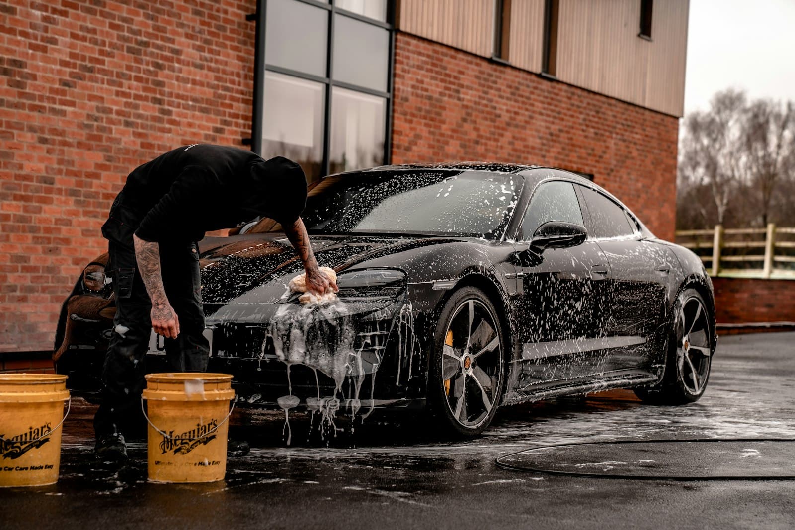 Detailer hand-washing a car
