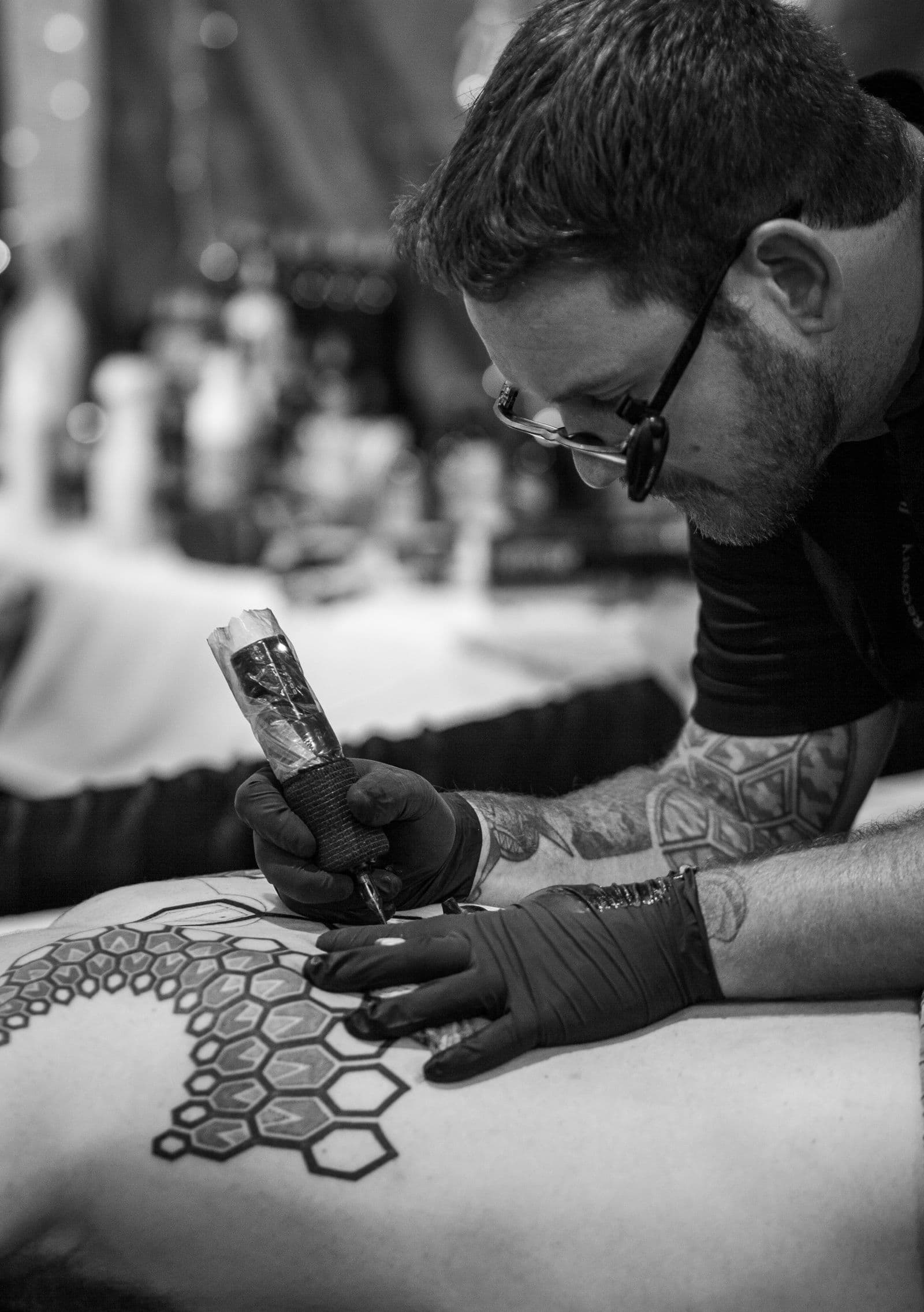 Artist tattooing a client